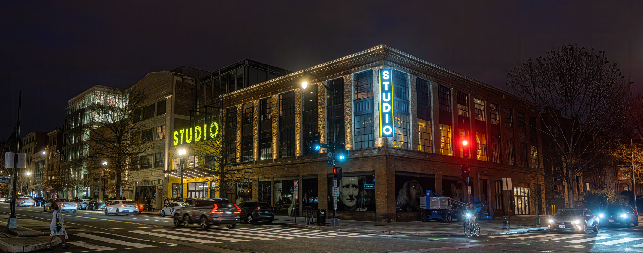 Nighttime photo of the corner of 14th and P Streets NW with Studio's lit marquee